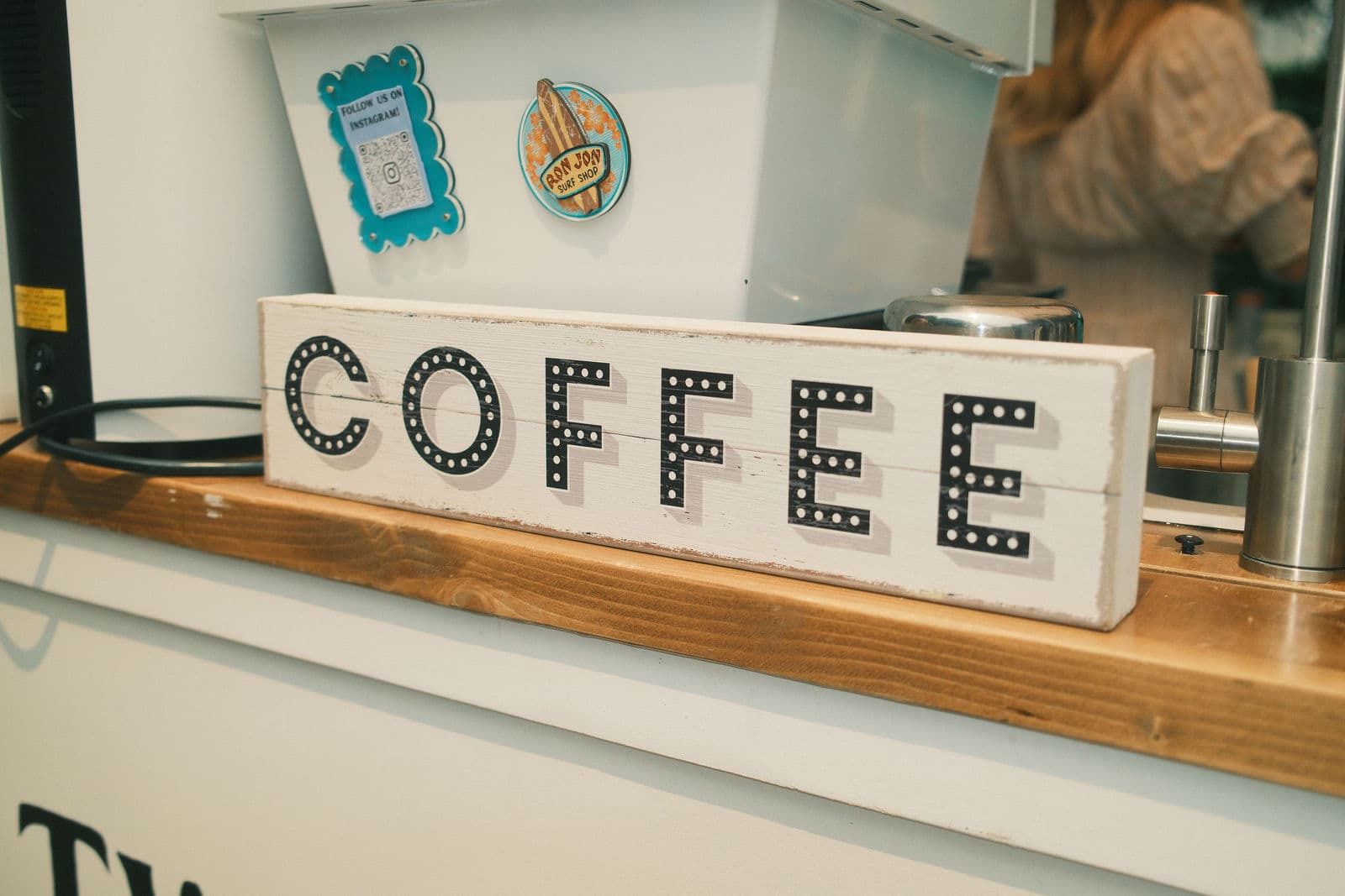 A marquee-letter COFFEE sign on the cart's wooden service ledge