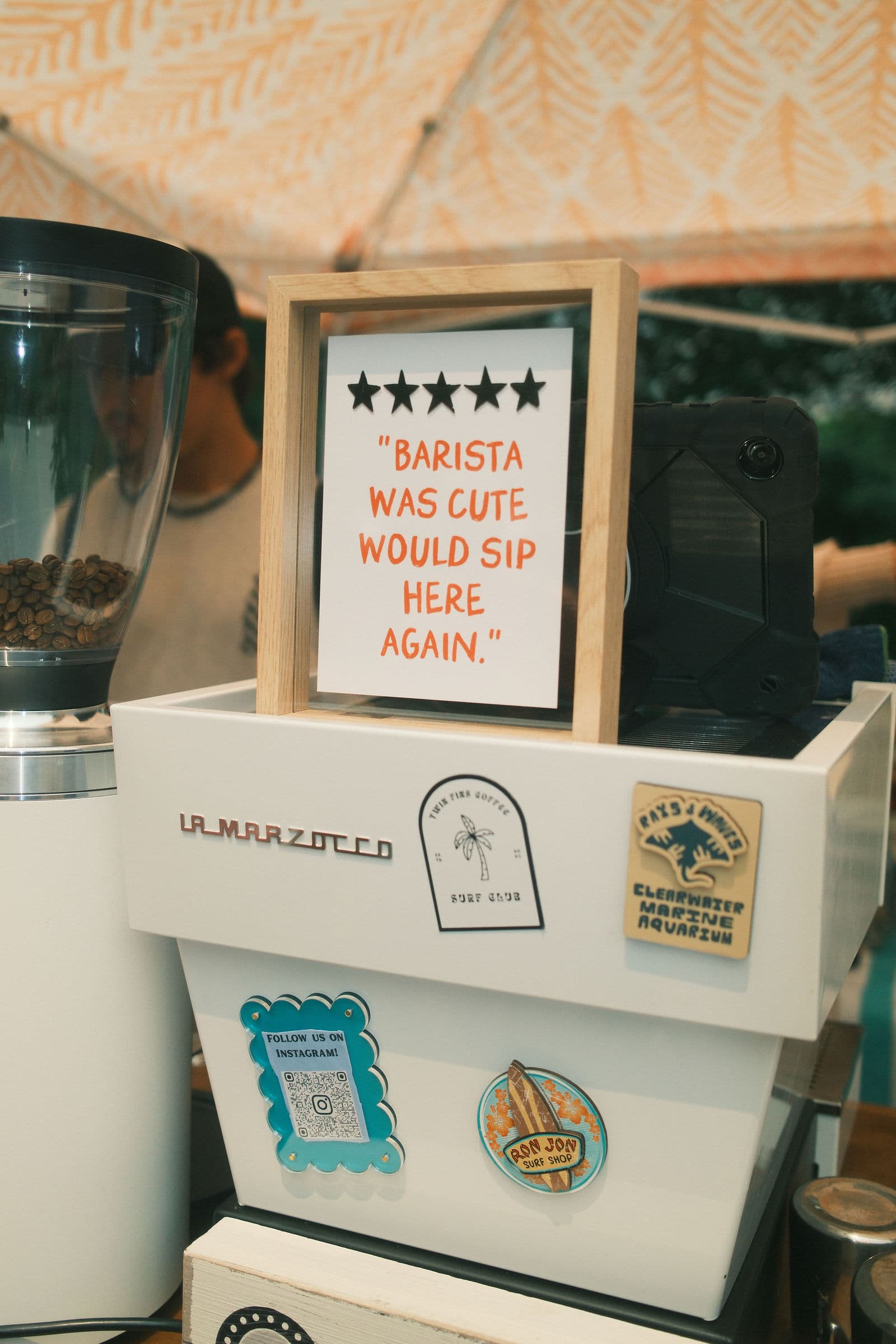 A framed five-star note on the cart's espresso machine reading: barista was cute, would sip here again